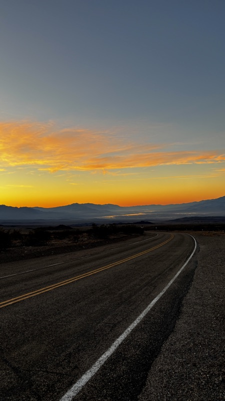 Desert road at sunset